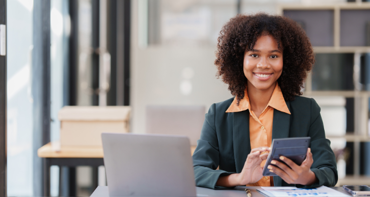 female accounting personnel working with a calculator and a computer