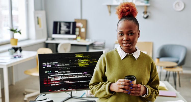 female database developer standing in front of desk