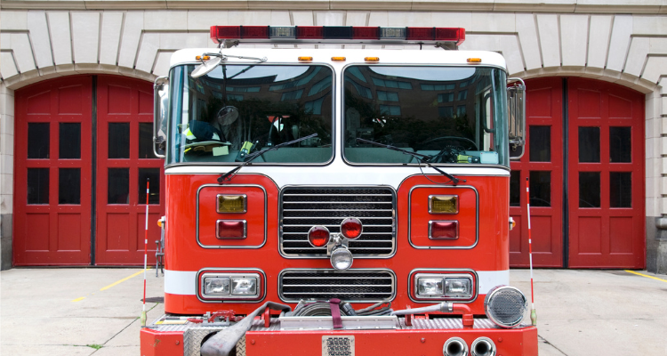 fire truck in front of a fire station