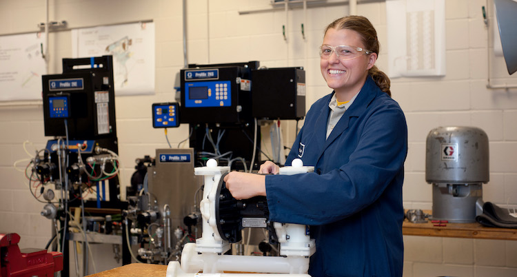 female industrial building engineer providing maintenance to equipment in lab