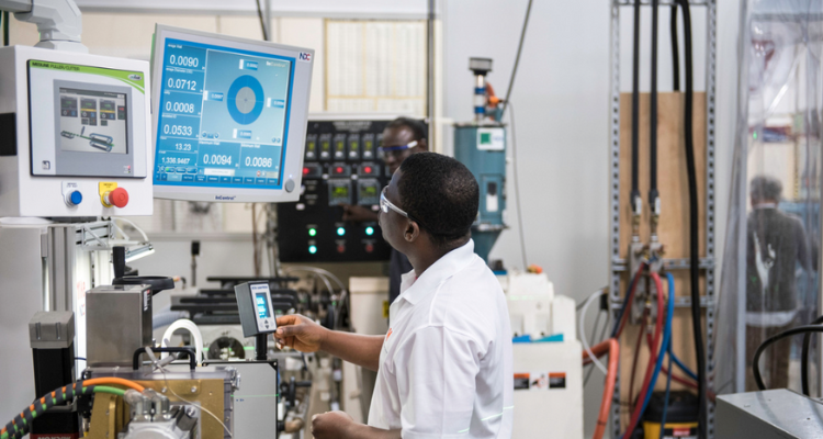 male student operating machine in lab