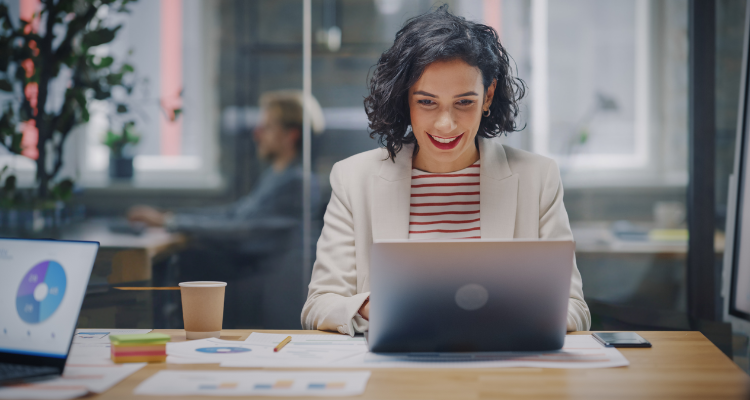 Female marketer working on a computer in a modern office