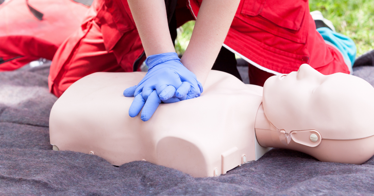 person practicing cpr on Annie dummy