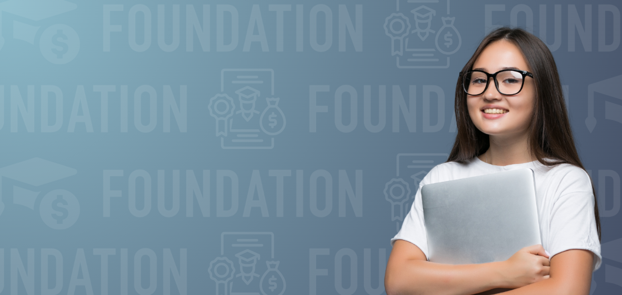 Smiling student holding a laptop against a blue background with the word 'FOUNDATION' and scholarship-themed icons