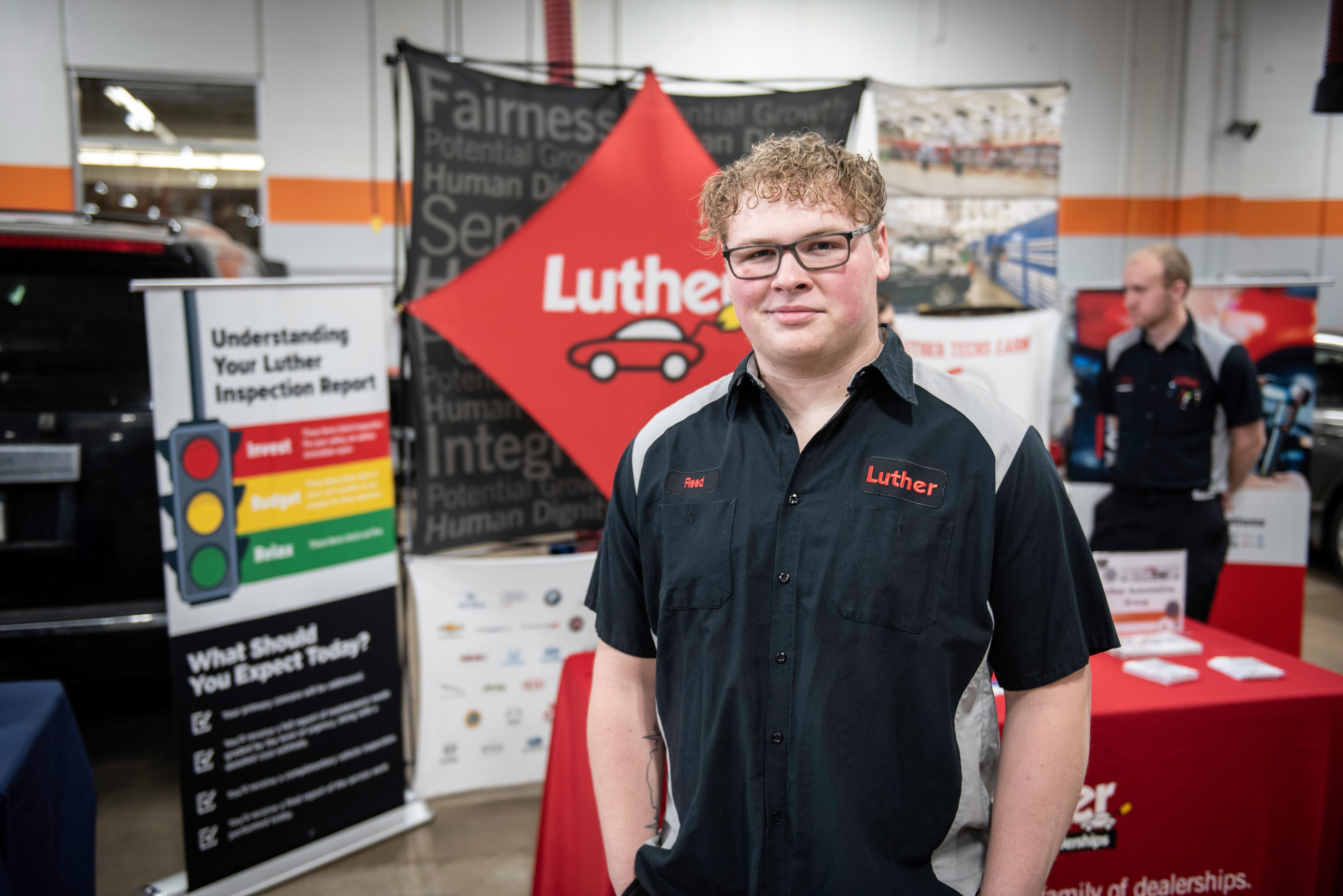 Alumnus Reed Greenwood in auto mechanic shop