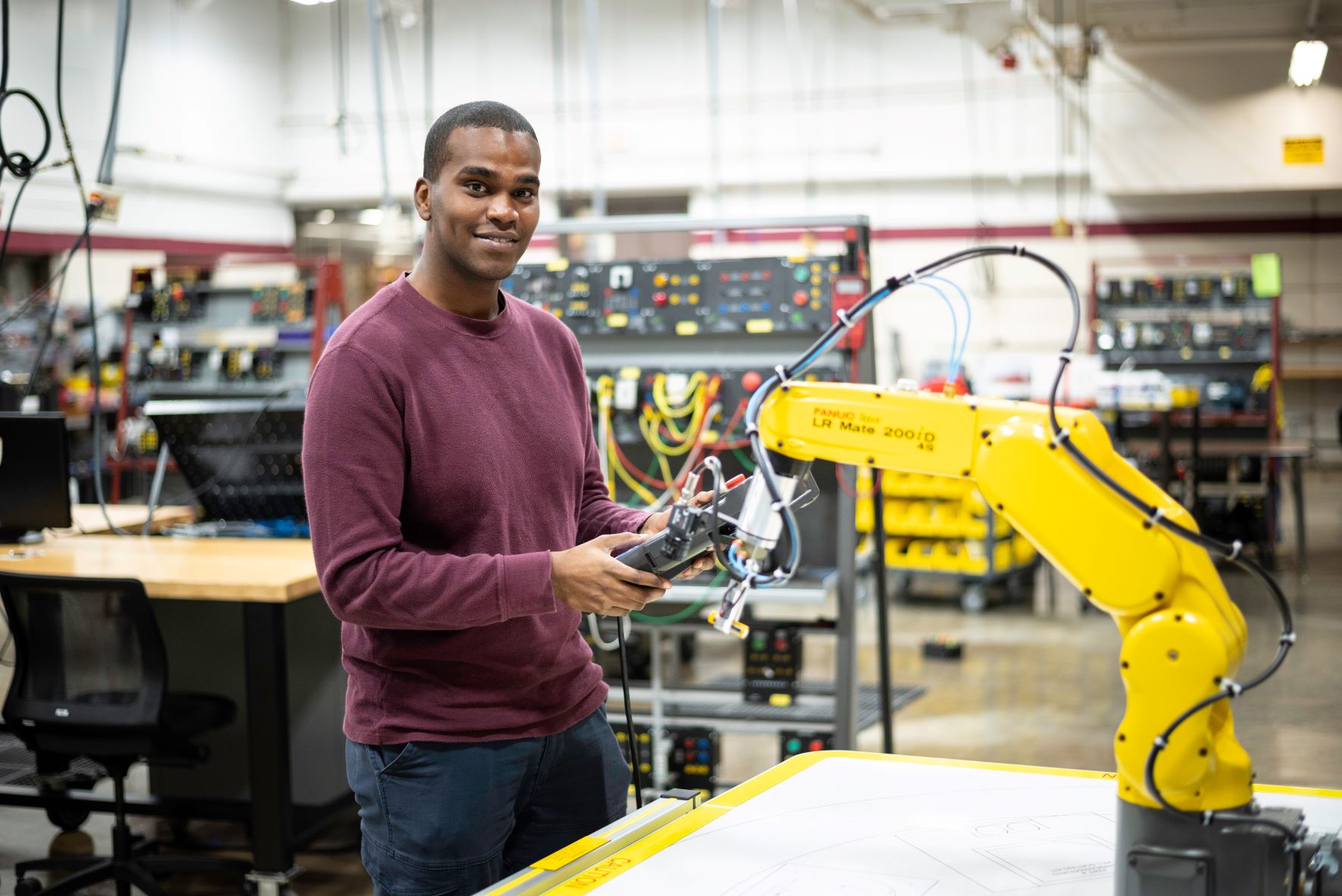 Robotics student with robot arm