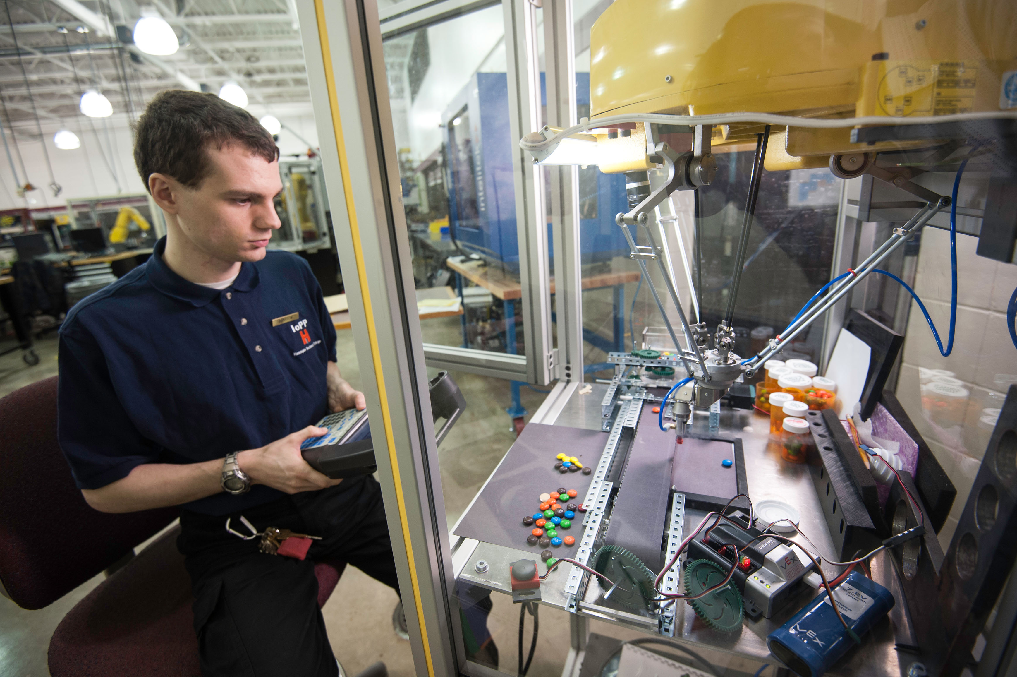 robotics student using equipment to move m & m candies