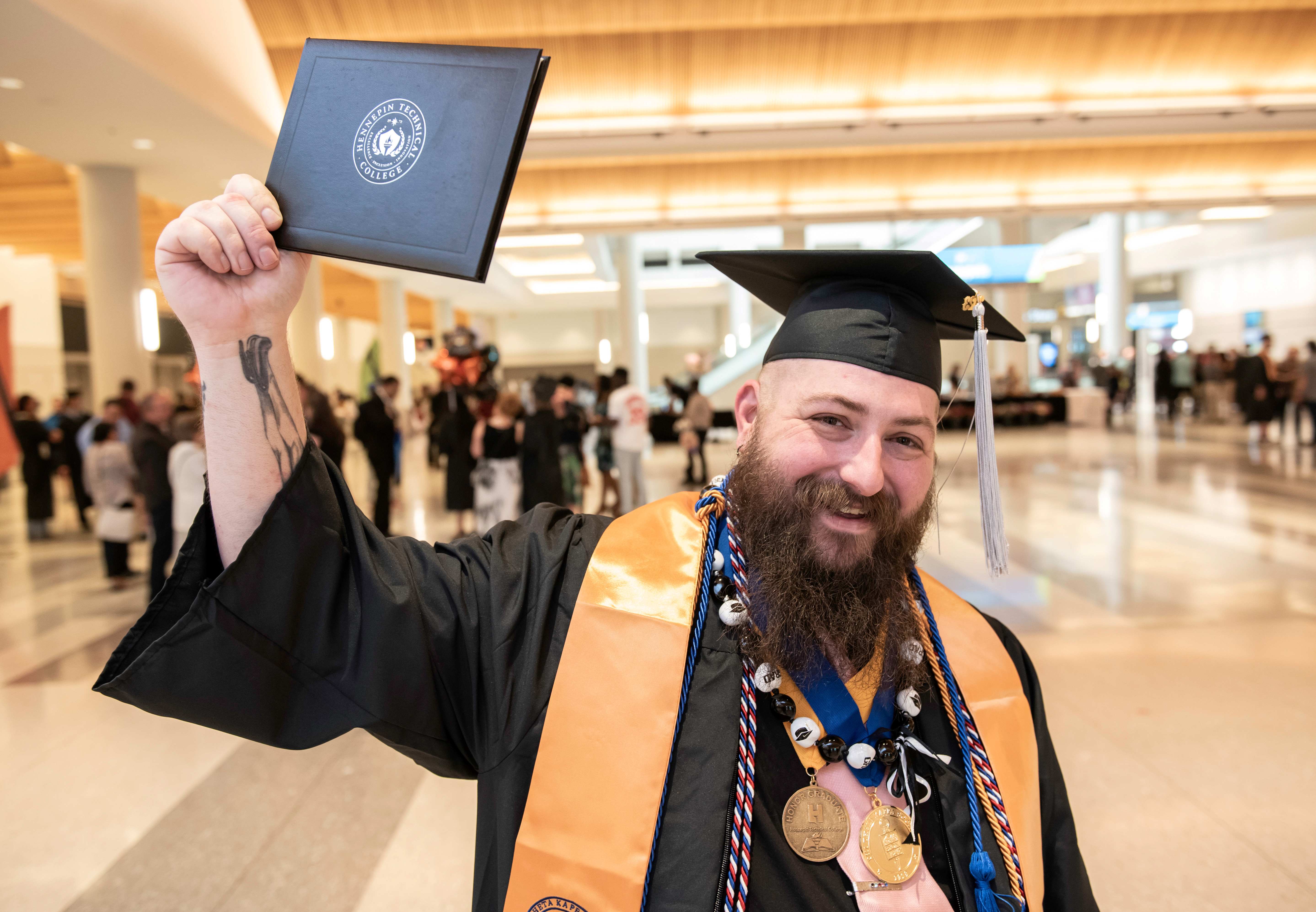 Graduate Brandon Jenumm holds award